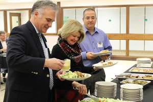 This is an image of board of education members serving themselves dinner