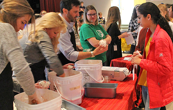 This is an image a student receiving a cup of ice cream