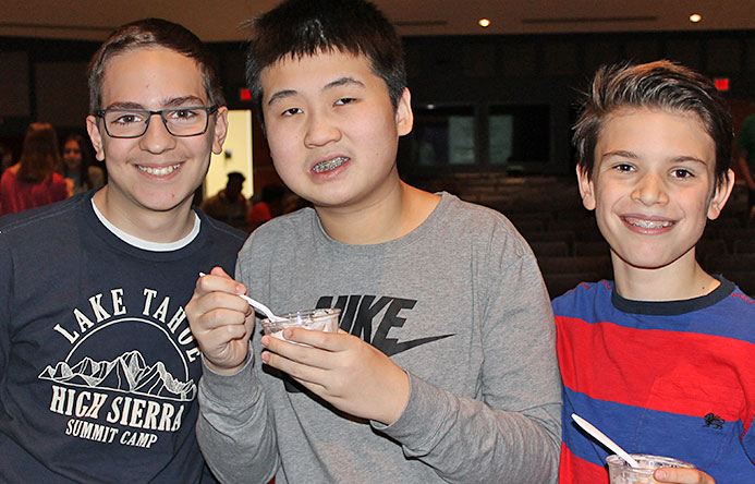 This is an image of three male students eating ice cream