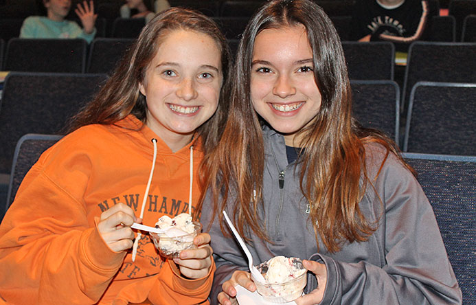 This is an image of two female students eating ice cream and smiling