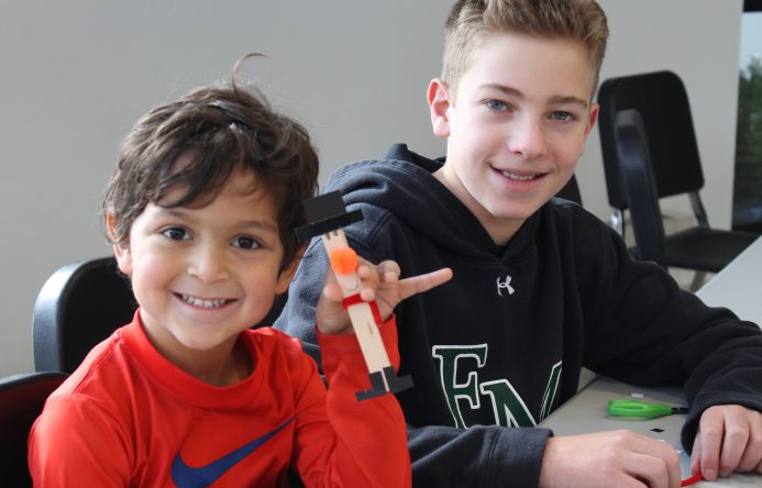 This is an image of two male students smiling