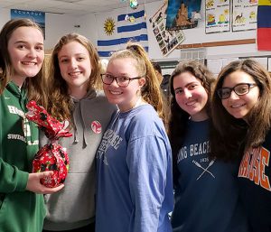 This is an image of five F-M High School students smiling and holding gifts