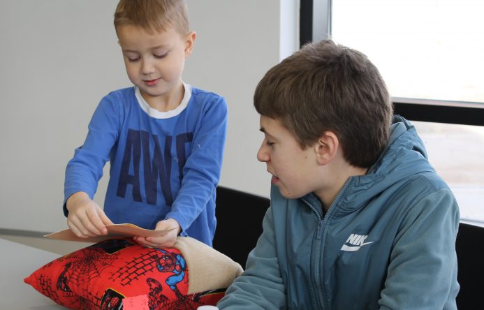 This is an image of a boy opening a memory book