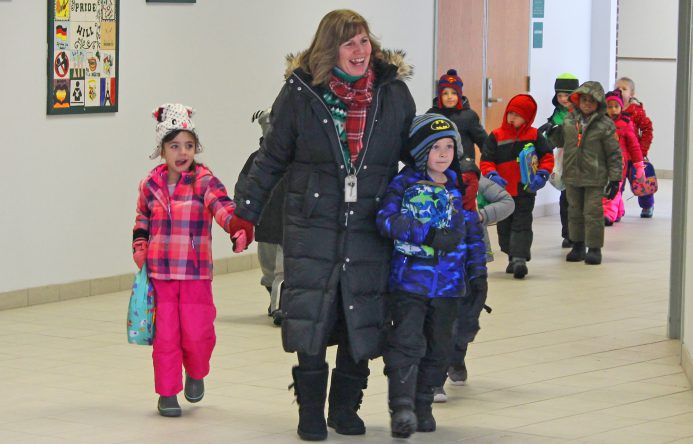 This is an image of Mrs. Lewis walking with students