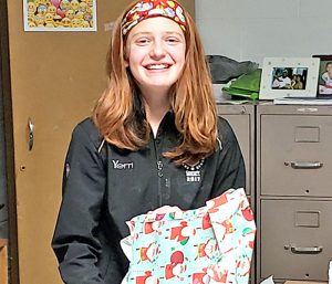 This is an image of an F-M High School student holding a gift and smiling