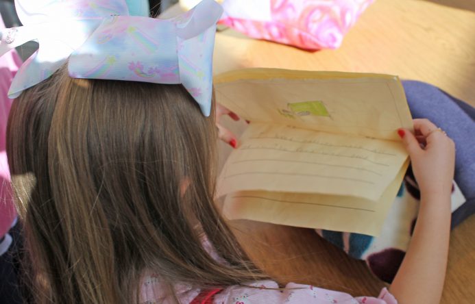 This is an image of a young student reading a memory book