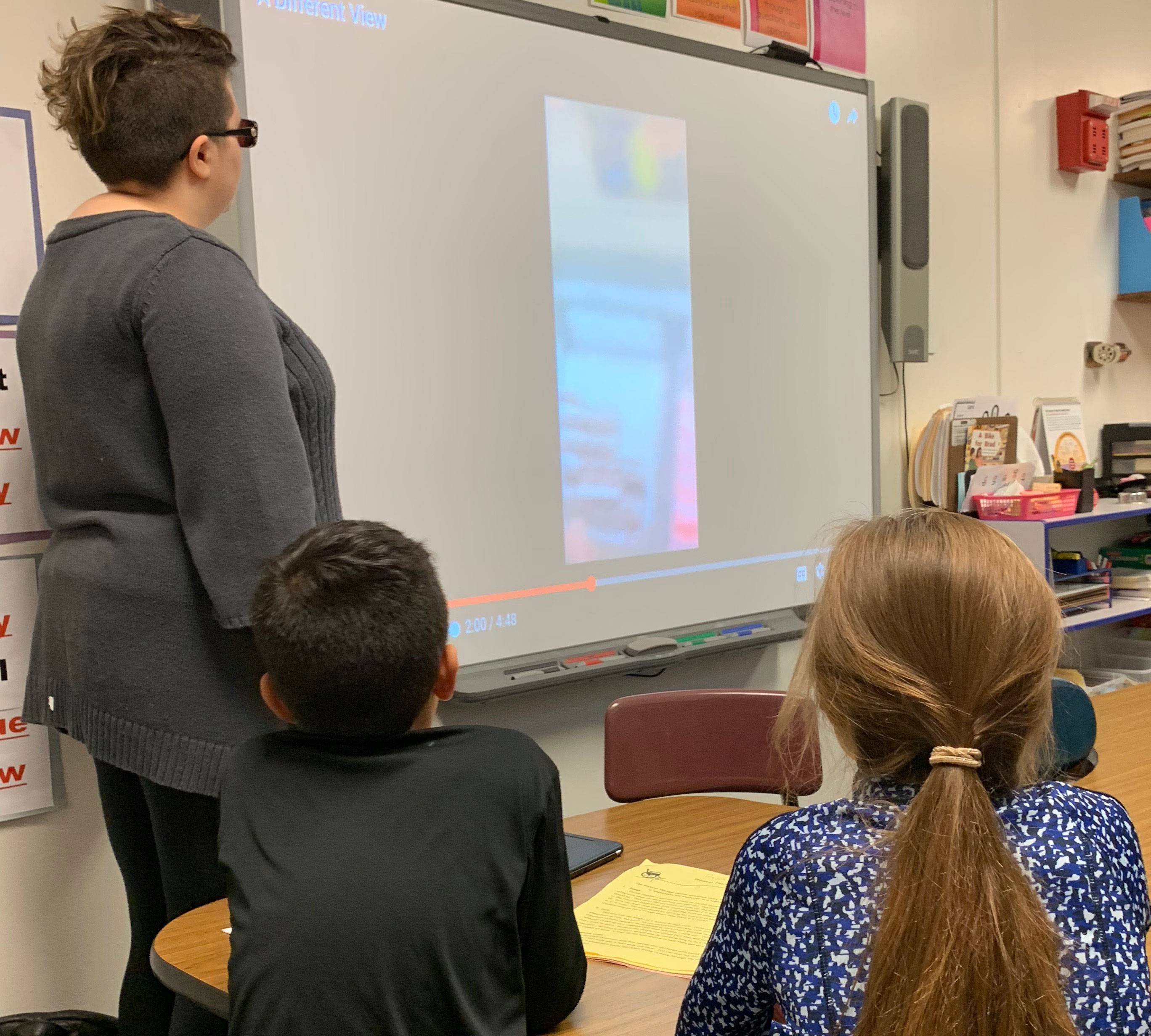 This is an image of an F-M student teaching younger students about vision impairments