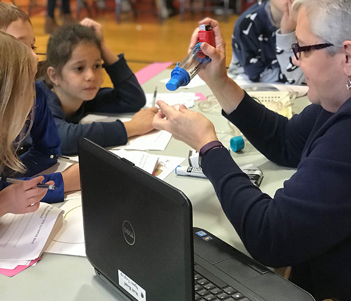 This is an image of two students watching a presenter