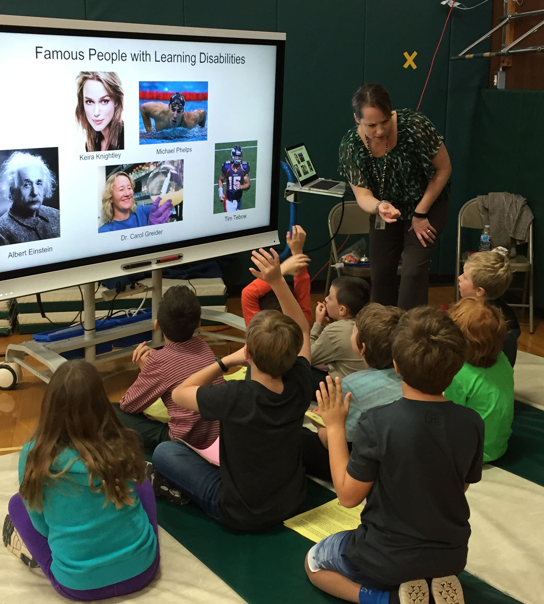 This is an image of a group of students watching a presentation