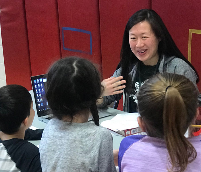 This is an image of a woman talking to students during the TEAM Day event