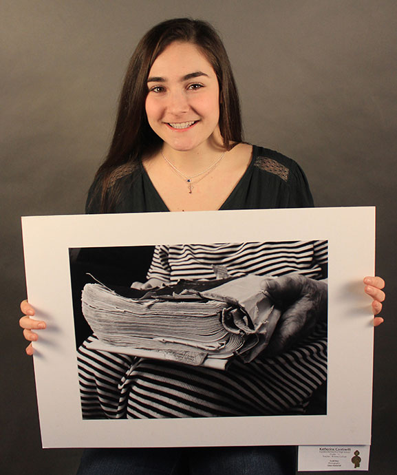 This is an image of an F-M student holding her artwork