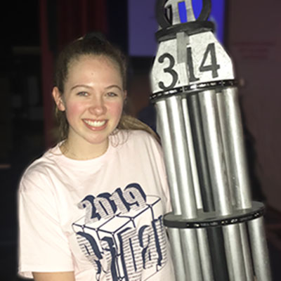 This is an image of Becca Ziobro holding the Pi Day trophy