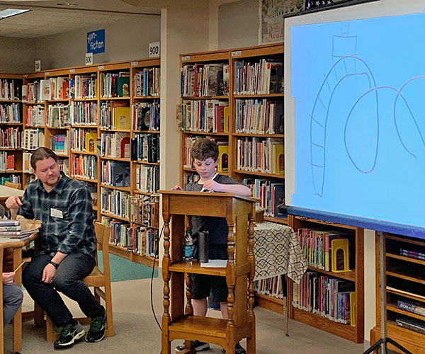 This is an image of a student drawing next to author Nathan Hale