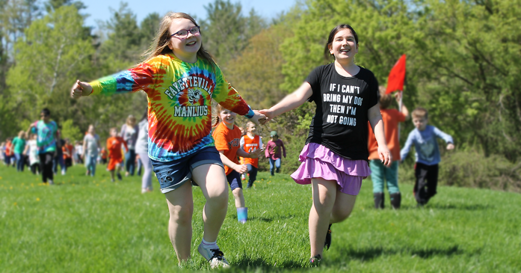 This is an image of two students holding hands