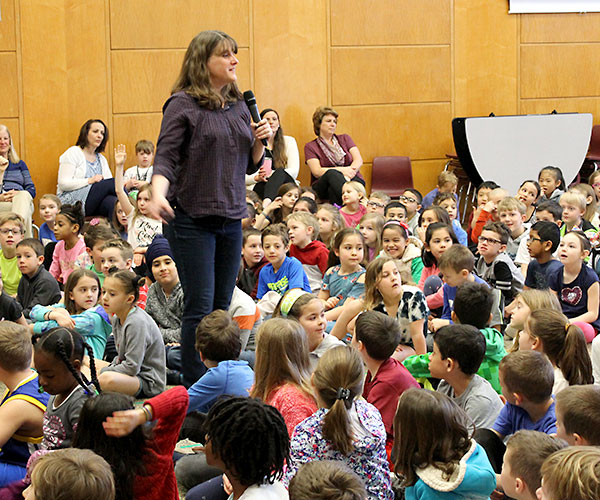 This is an image of Kate Messner talking to elementary school students