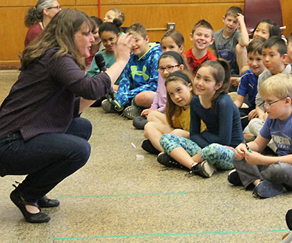 This is an image of Kate Messner talking to students