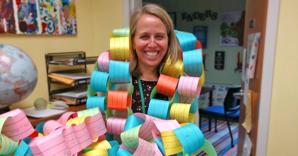 This is an image of Principal Capri holding a paper chain