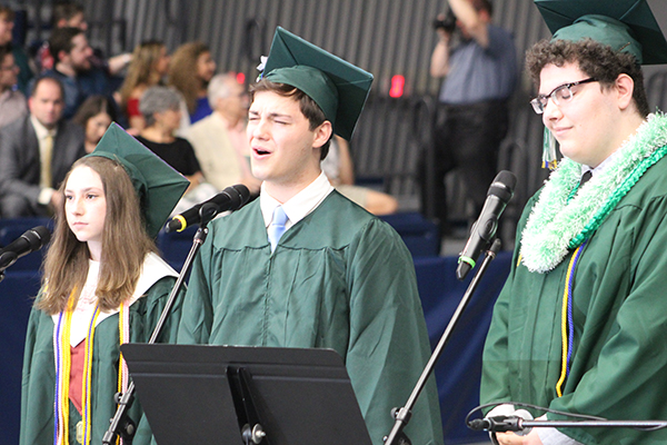 This is an image of three students singing