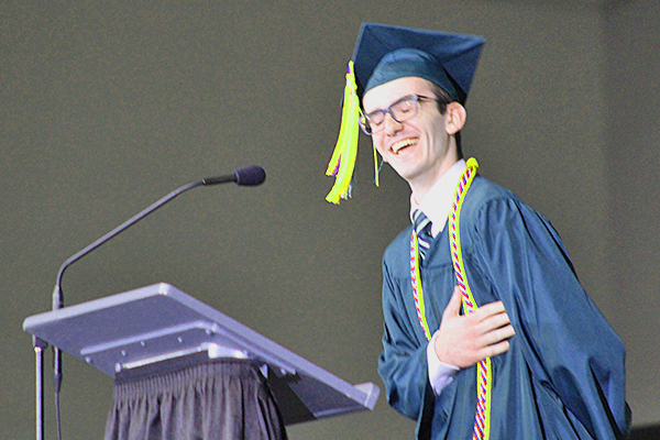 This is an image of a student laughing at graduation