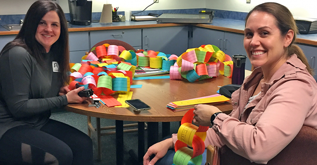 This is an image of parent volunteers making a paper chain