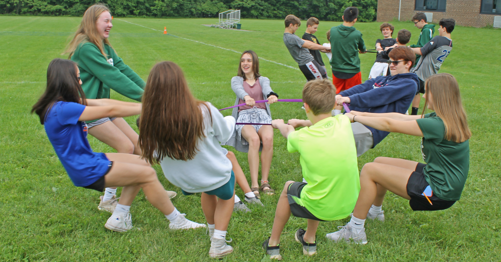 This is an image of students performing the raccoon circle activity