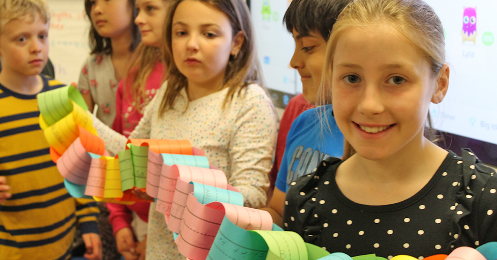 This is an image of students holding a paper chain