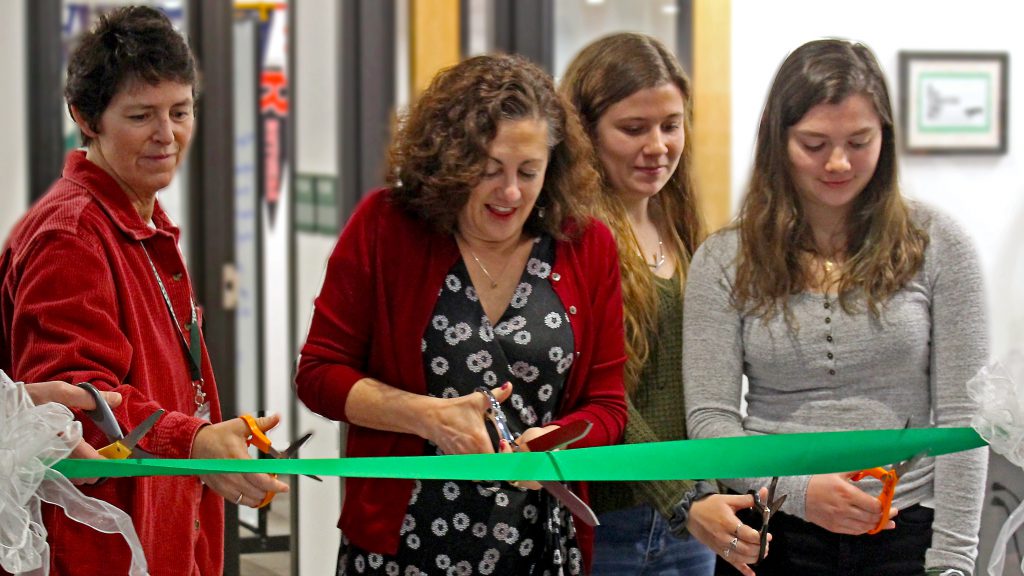 This is an image of students and staff cutting a ribbon