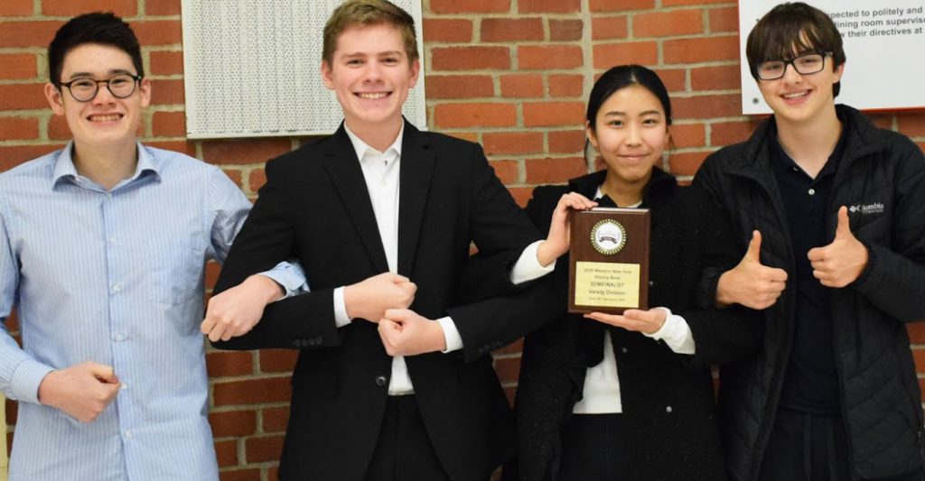 This is an image of four students smiling