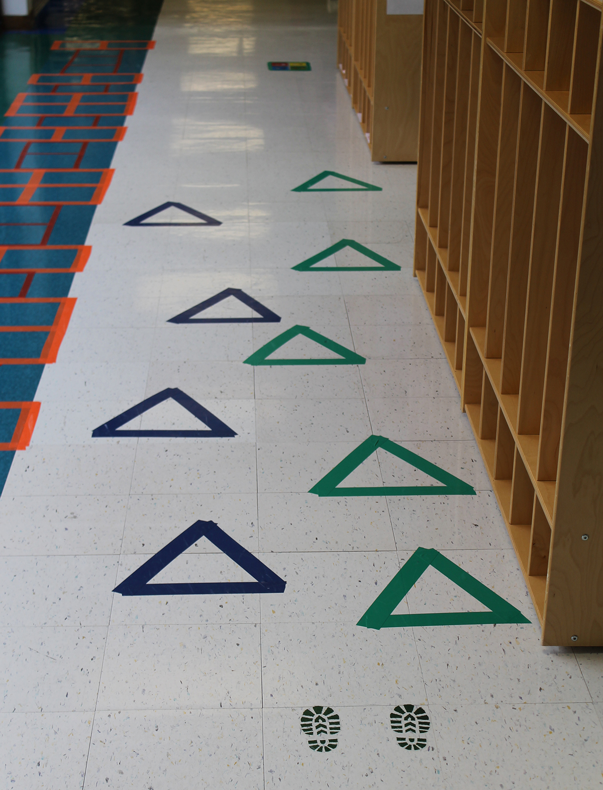Triangle stickers on a hallway floor