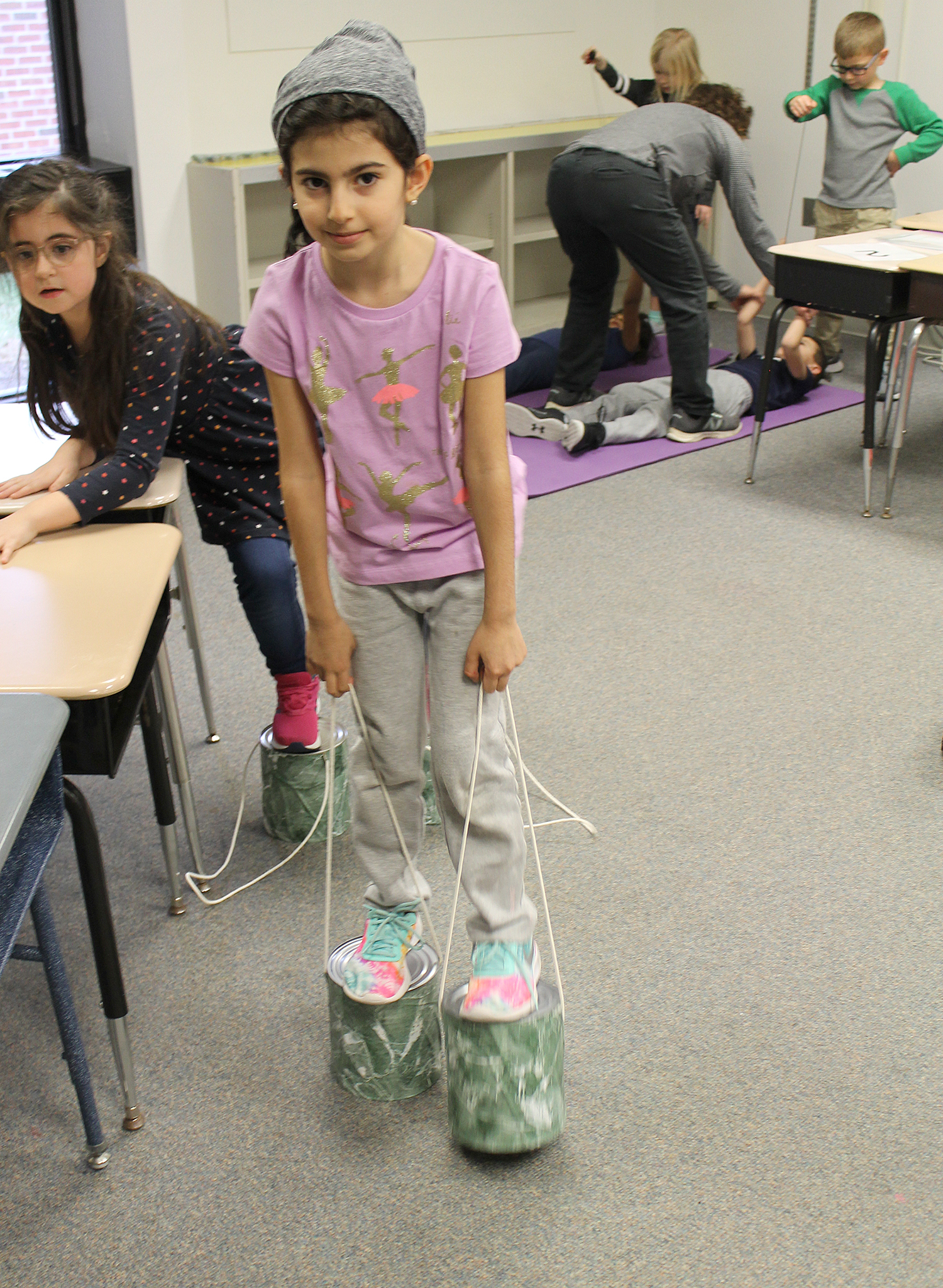 Student walking on pant cans.