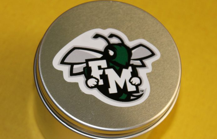 round silver container with F-M hornet logo on top.