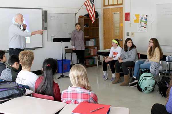 This is an image of students sitting in a classroom listening to Eisen and Paul speak.