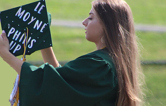 This is an image of a student holding a graduation cap