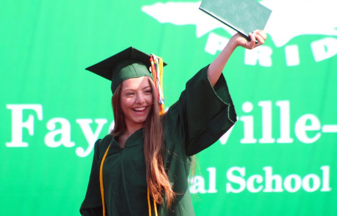 This is an image of a student holding a diploma