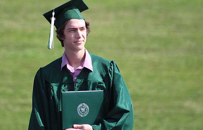 This is an image of a graduate holding his diploma