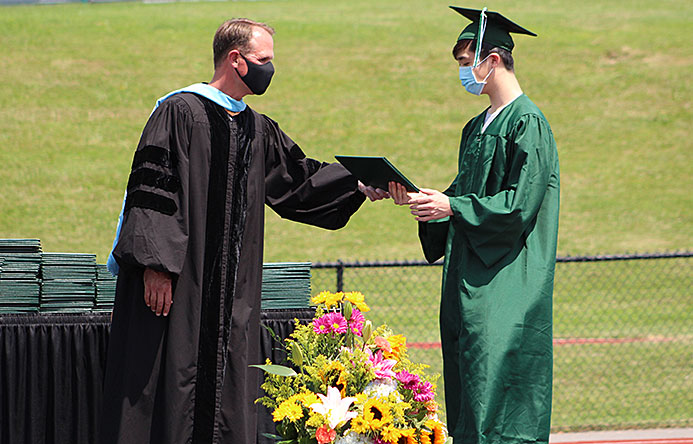 This is an image of a graduate receiving a diploma