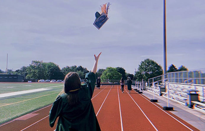 This is an image of a graduate throwing his cap