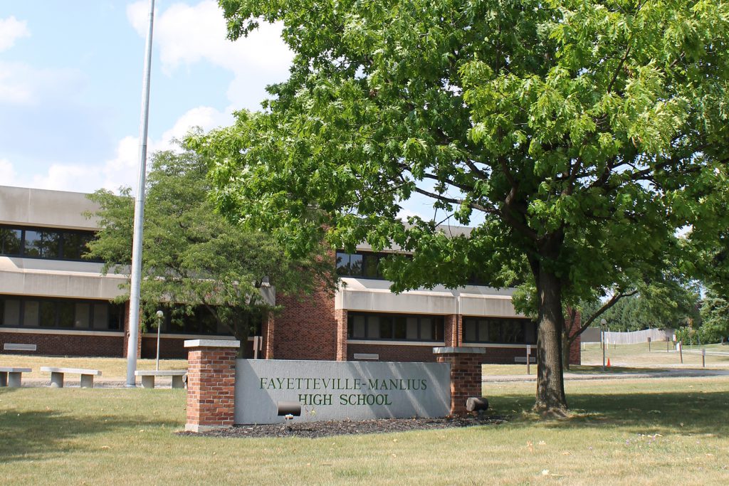 School name sign in front of building. 