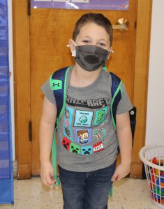 student standing by door wearing a Minecraft t-shirt.