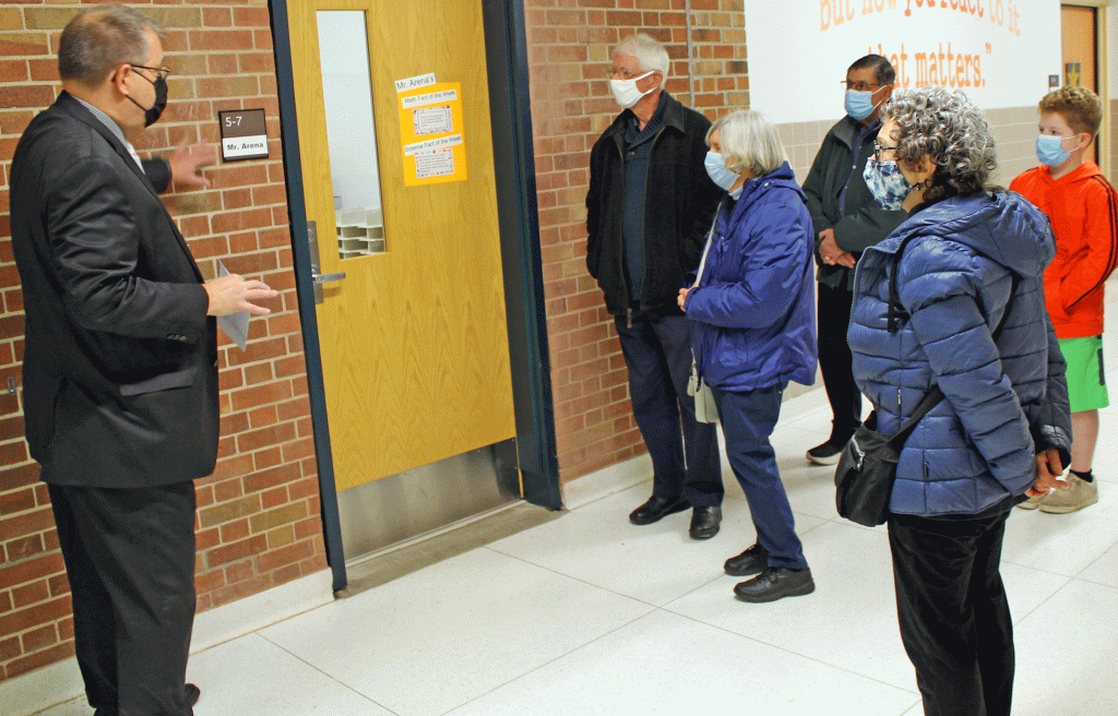 This is an image of individuals walking through a hallway at Wellwood