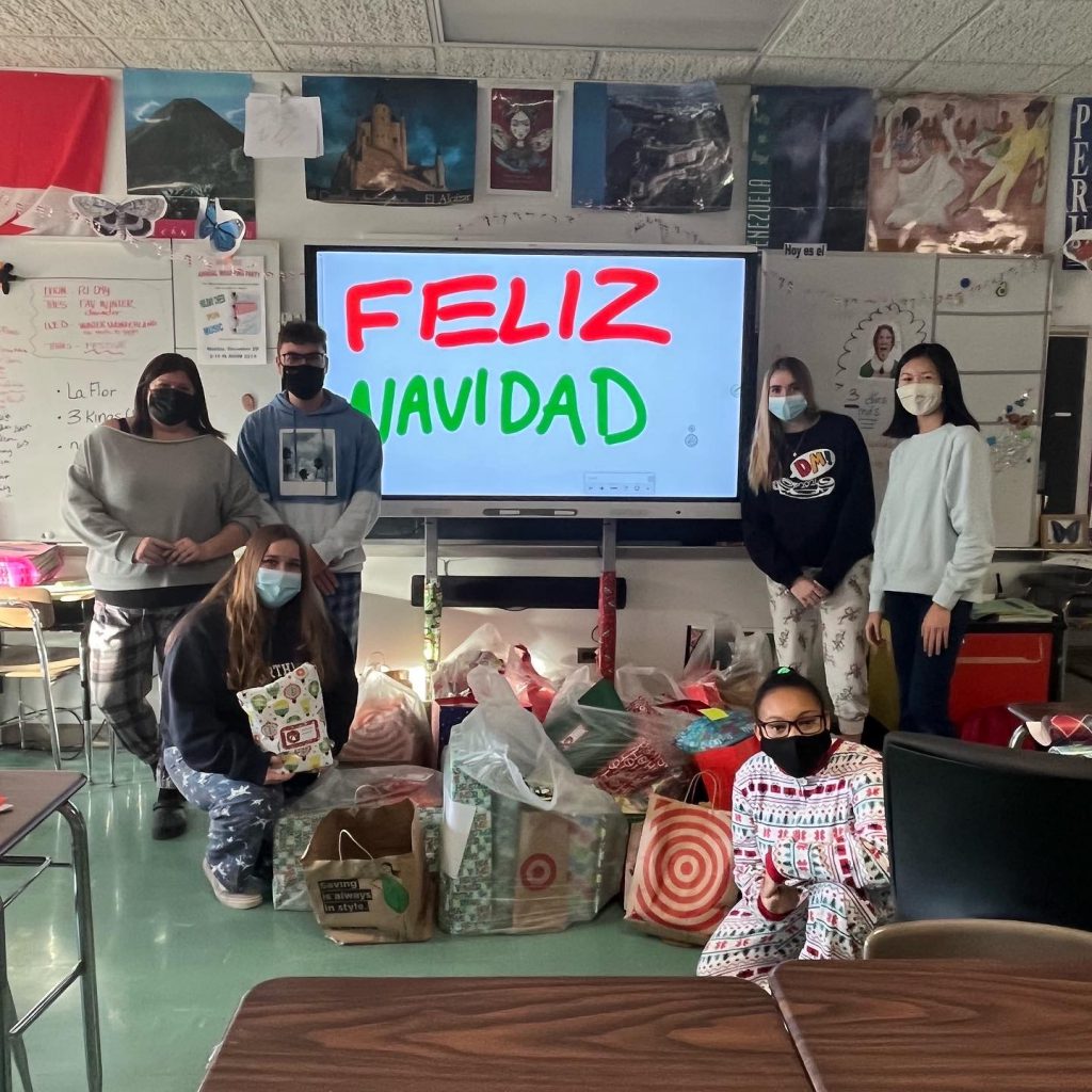 This is an image of several high school students standing together during a gift-wrapping event