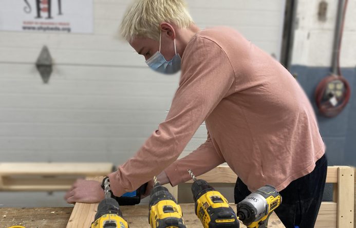 This is an image of a student measuring a board