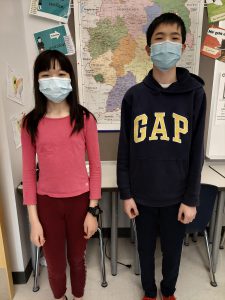 Two students standing side-by-side