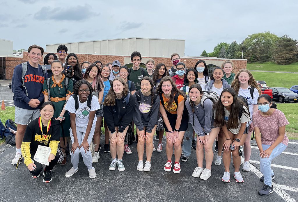 Group of students standing together outside a school. 