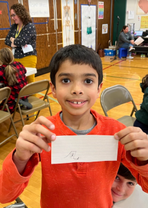 A student shows off his written Chinese