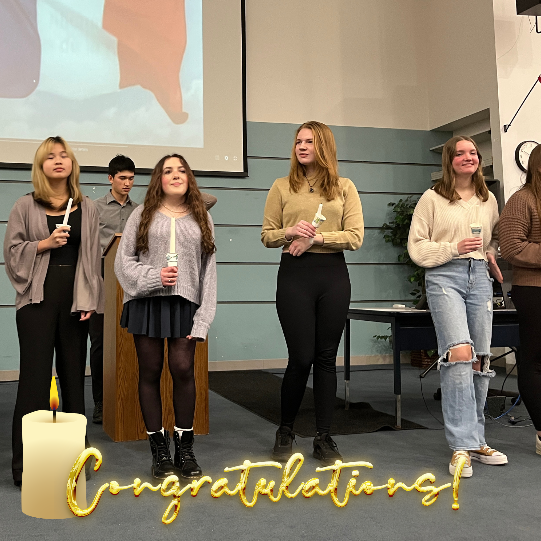 Several high school students stand together during the National French Honor Society induction ceremony