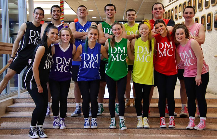 Fourteen high school students who are the 2023 Fayetteville-Manlius High School Dance Marathon MCs stand together for a photo
