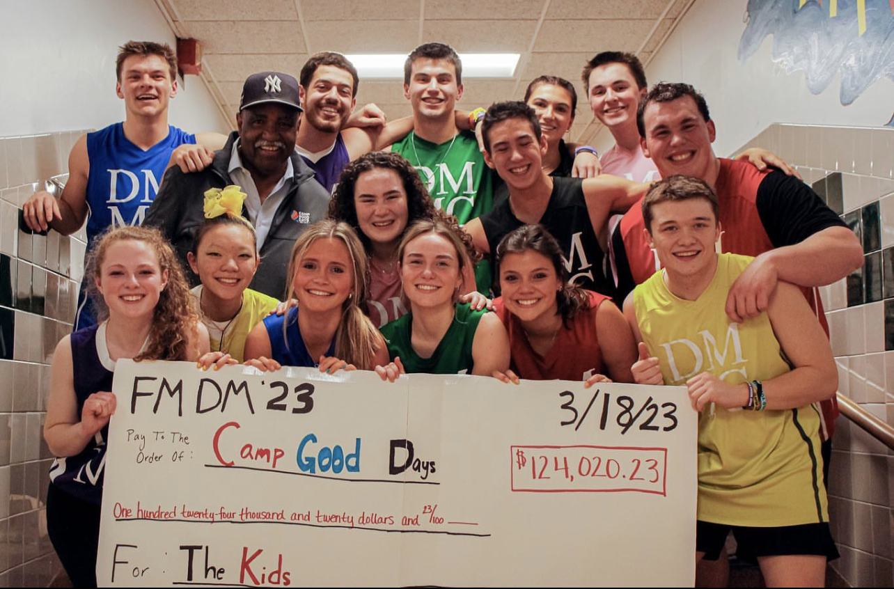 A group of F-M High School students hold a large-sized check that is written out to Camp Good Days.