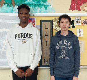 Christopher Shanguhyia and Nathan Liu posed for the camera in front of a bulletin board.