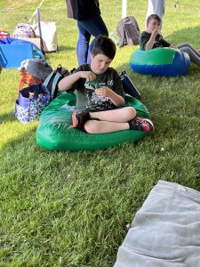 A Special Olympian student-athlete is pictured sitting on grass